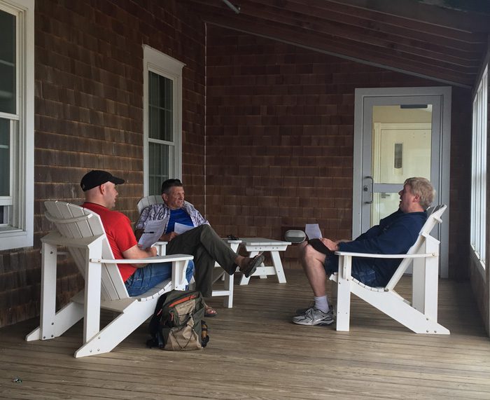 mens-ministry Men talking on a porch